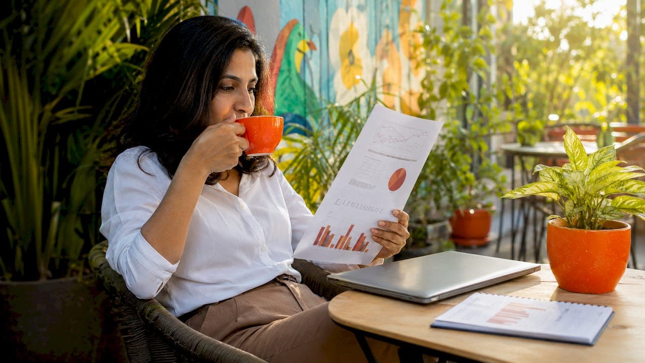 Businesswoman reviewing B2B backlink report at table